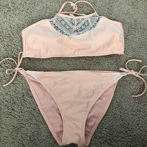 Women’s peach colored bikini with lace edges